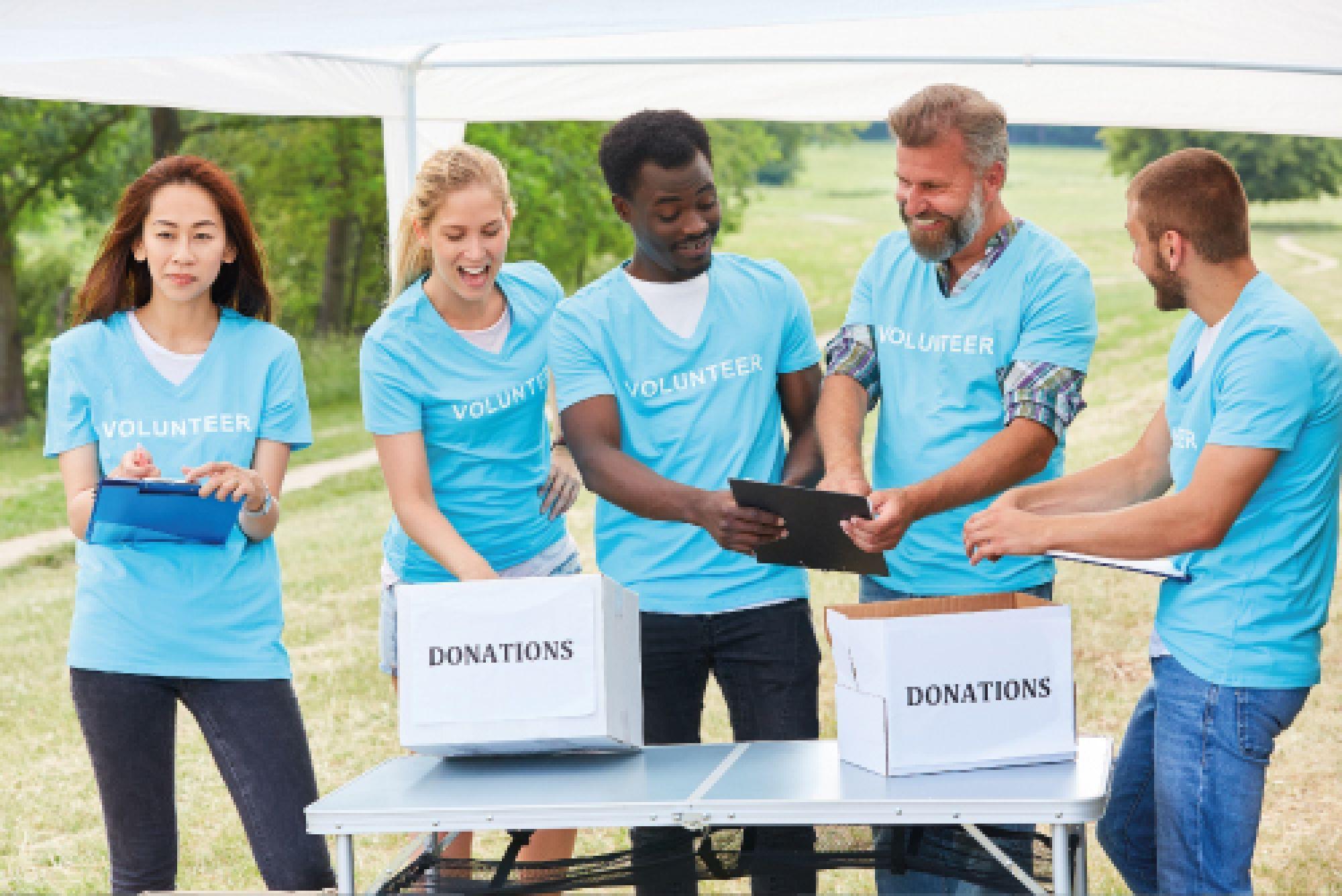 Volunteers collecting donations at an outdoor fundraising table