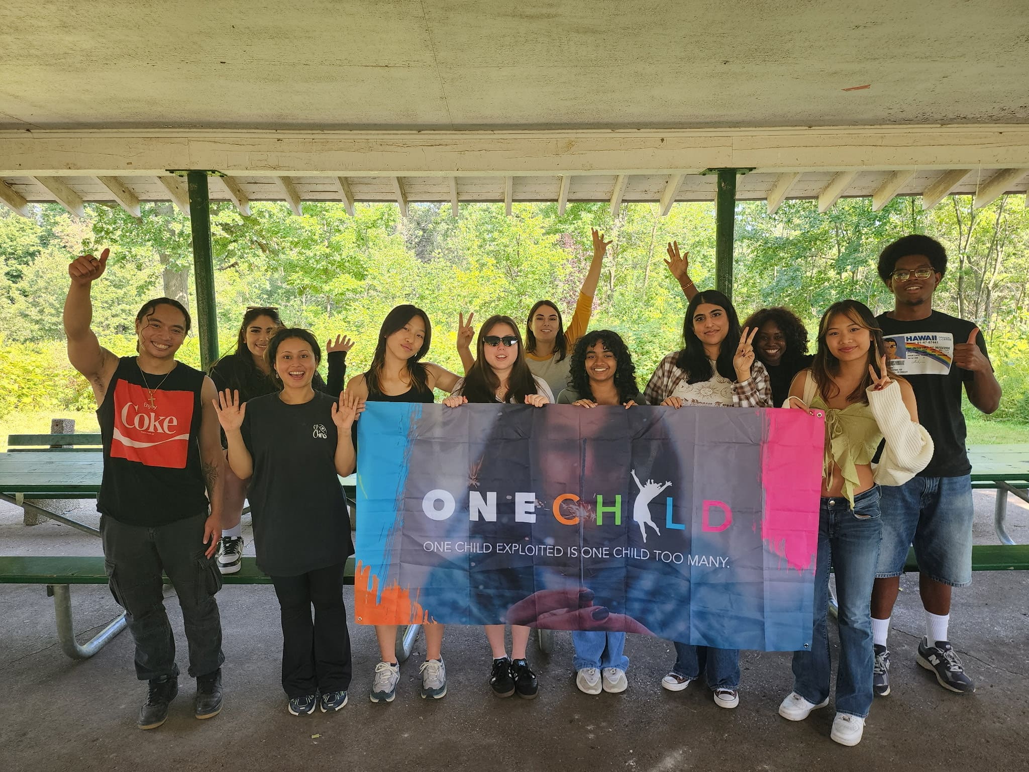 Young people holding a OneChild banner reading “One child exploited is one child too many.”