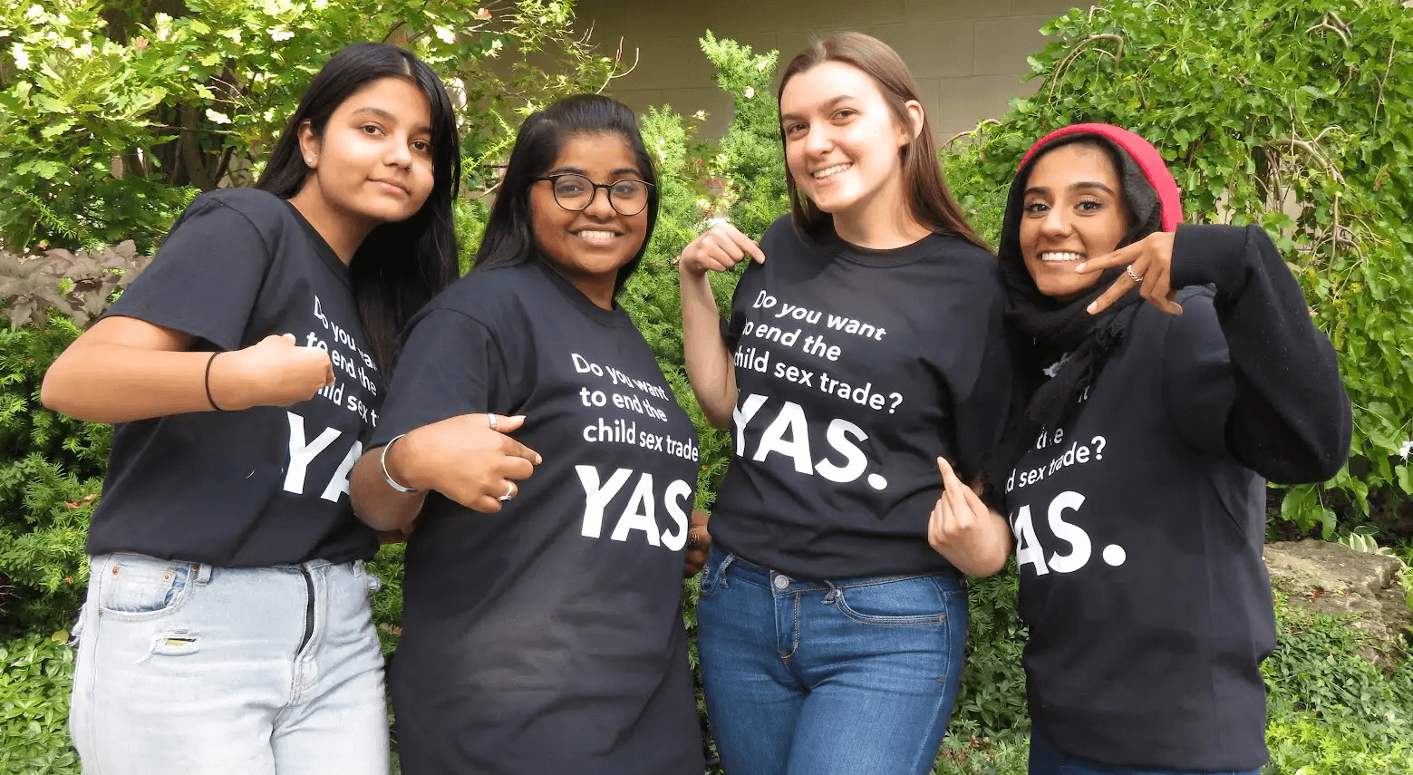 Four Youth Advisory Squad members in YAS t-shirts reading “Do you want to end the child sex trade? YAS.”
