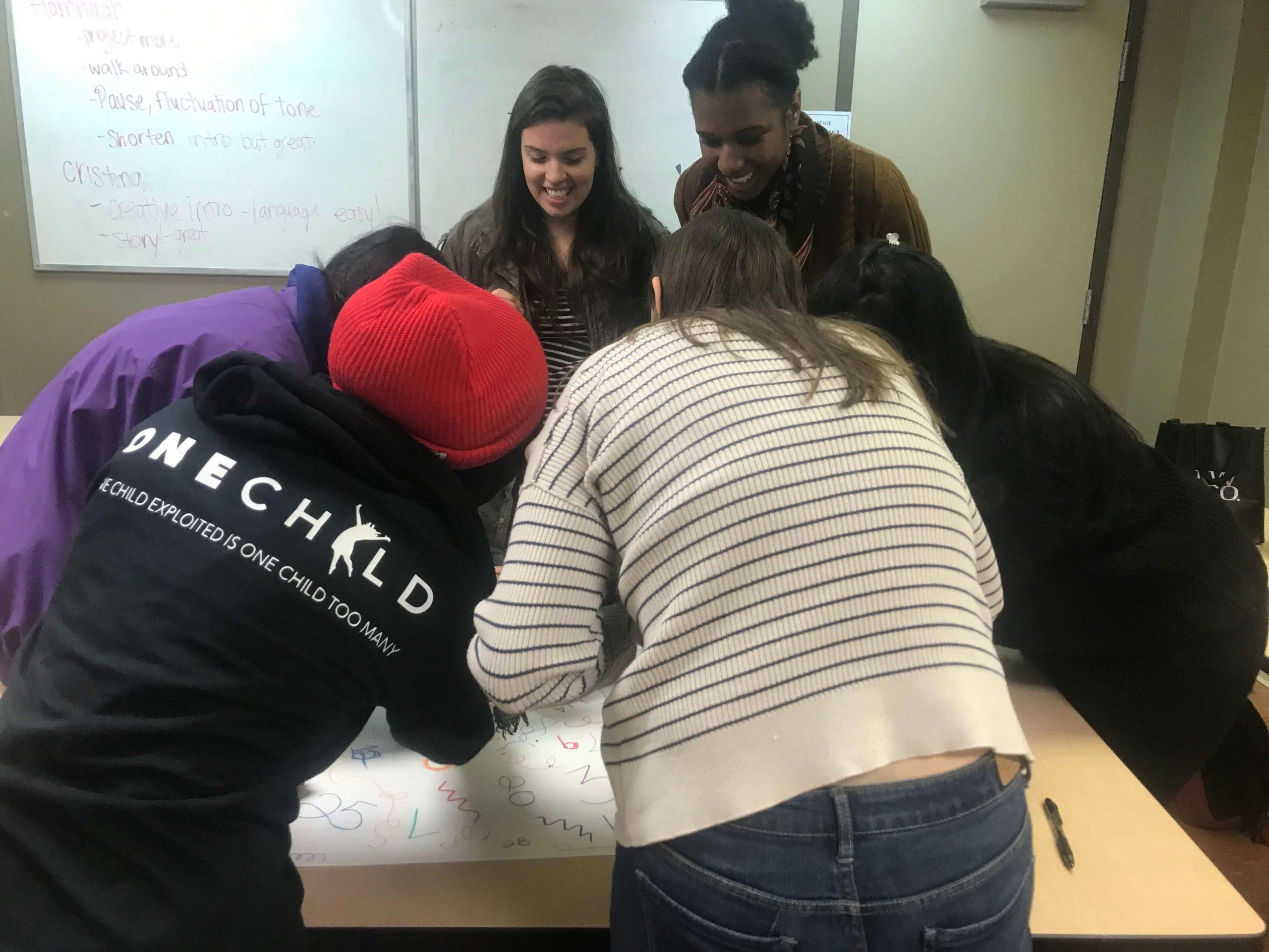 Young people working together around a table during a OneChild workshop